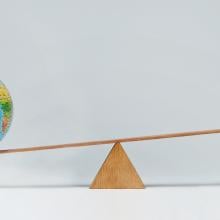 globe and piggy bank balancing